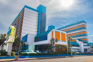 a large office building with palm trees in front of it at Modern & Updated Oceanview Studio! Sleeps 4! Landmark 523 in Myrtle Beach
