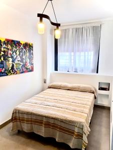 a bedroom with a bed with a painting on the wall at Vera Holydays in Torremolinos