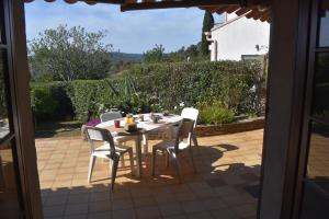 a table and chairs sitting on a patio at Petite maison provençale pour 4 personnes in Bormes-les-Mimosas