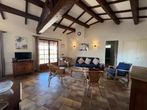 a living room with a couch and a table at Petite maison provençale pour 4 personnes in Bormes-les-Mimosas