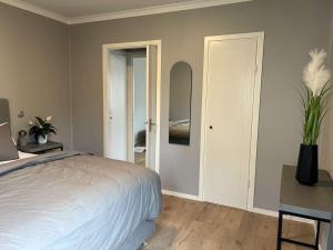 a bedroom with a bed and a table and a mirror at Newly refurbished Apartment in Västervik