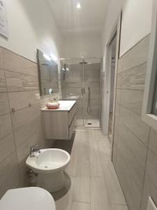 a bathroom with a toilet and a sink and a shower at Il Sogno di Francesca in Alghero +2 photos