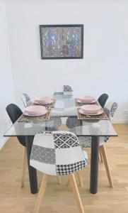 a dining room table with chairs and a glass table at Chic&Cosy 1-Bedroom Apart,2 min Metro,10 min Paris in Villejuif +18 photos