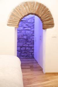 an archway in a bedroom with a stone wall at Casa di Giò in Todi
