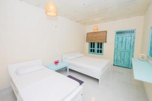 Postelja oz. postelje v sobi nastanitve Capital Trincomalee