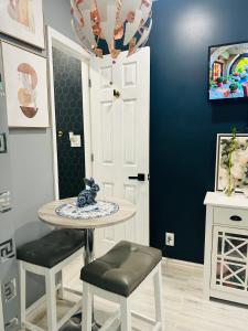 a dining room with a table and two stools at Fancy Studio Private Entrance in Selden