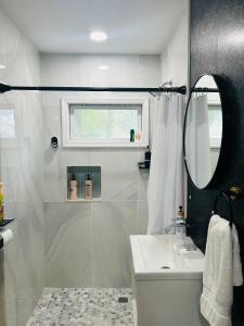 a white bathroom with a sink and a mirror at Fancy Studio Private Entrance in Selden +21 photos