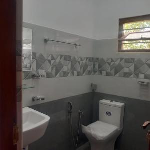 a bathroom with a toilet and a sink at Yelona Rest in Galle