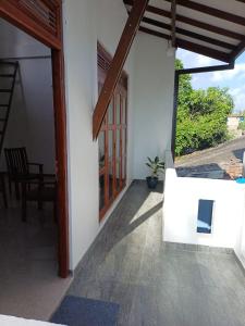 an open door of a house with a patio at Yelona Rest in Galle