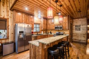a kitchen with wooden cabinets and a counter with bar stools at Time Well Wasted in Stephens Gap