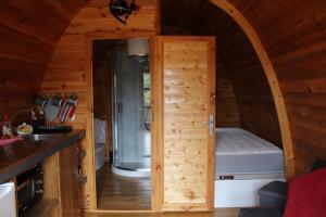 a small kitchen with a door in a tiny house at Quinta da Devesa -B2 in Vinhais +24 photos