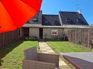 a house with an orange umbrella in the yard at Maison au calme idéale pour découvrir Sud Finistère in Quimper