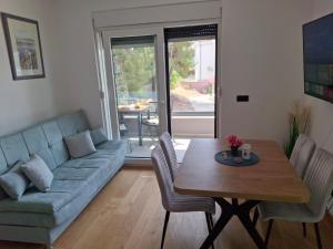 a living room with a couch and a table at Prvi red do mora in Zablaće