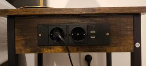 a speaker on a wall with a cord plugged into it at Apartment Orlińskiego in Kraków