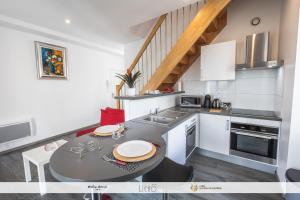 a small kitchen with a table and a sink at Gîte Maison Planté a5 - Argeles-Gazost in Argelès-Gazost