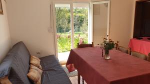 een kamer met een tafel, een bank en een raam bij Vila Cosovic in Citići