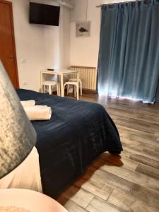 a bedroom with a bed and a table with chairs at Brezza Marina Studios in Montesilvano