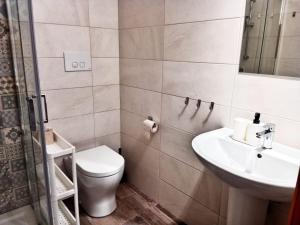 a bathroom with a toilet and a sink at Brezza Marina Studios in Montesilvano +25 photos
