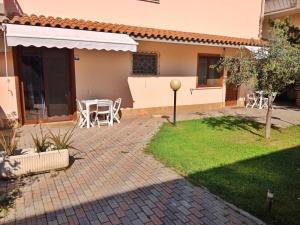 a patio of a house with a table and chairs at Brezza Marina Studios in Montesilvano