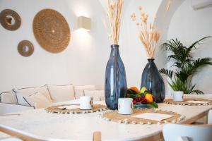 two blue vases sitting on a table with fruits at Casa vacanze la bella Tina in Polignano a Mare