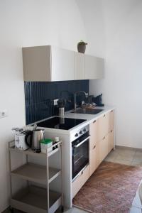 a kitchen with a sink and a stove at Casa vacanze la bella Tina in Polignano a Mare