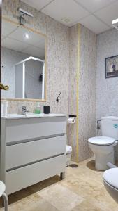 a bathroom with a sink and a toilet and a mirror at Loft céntrico en Ronda cercano al Tajo y Plaza de Toros con Wifi y Parking Opcional in Ronda +35 photos