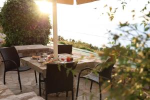 a table and chairs sitting on a patio at Panorama Rooms in Pyrgos Dirou