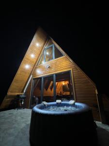 a room with a tub in front of a house at Vikendica miRAJ Manjaca in Gornje Ratkovo