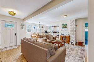 a living room with a couch and a table at Captains Cottage on Atlantic in Boothbay Harbor