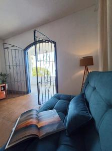 a book sitting on top of a couch in a living room at Linda Casa Com Vista Para a Praia! in São Pedro da Aldeia