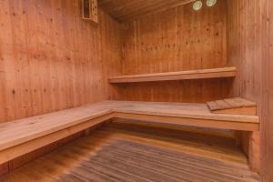 a wooden sauna with a bench in it at Hotel Tres Anclas in Gandía