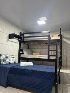 two bunk beds in a room with a blue bed at Casa próximo parque de eventos com piscina aquecida na temporada in Bento Gonçalves +36 photos