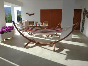 a hammock in a living room with a table at Asprocyclia House in Kalymnos