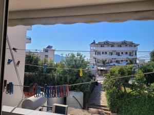 a view from a window of a house with clotheslines at Geri Apartment in Ksamil