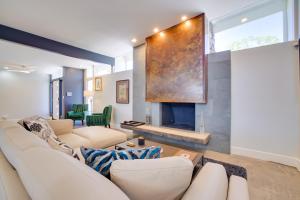 a living room with a couch and a fireplace at 3 Mi to Strip Mid-Century Gem with Hot Tub in Vegas in Las Vegas
