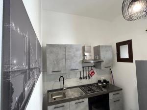 a kitchen with a sink and a stove at La Cupola - casa vacanze n 8 in Termini Imerese