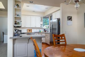 a kitchen with a table and a refrigerator at Ocean Ranch Retreat Monthly Rental in Cambria +18 photos