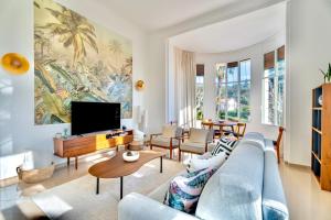 a living room with a blue couch and a tv at Appartement unique - 6 personnes - Clim Terrasse Parking Plages in Saint-Raphaël