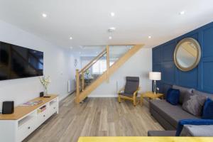 a living room with a couch and a table at Castle View - 2 Bed Stylish Coastal Port Solent Retreat with Views! Parking, Sleeps 6 - By Blue Puffin Stays in Portsmouth