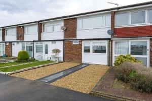 a brick house with white doors and a driveway at Castle View - 2 Bed Stylish Coastal Port Solent Retreat with Views! Parking, Sleeps 6 - By Blue Puffin Stays in Portsmouth
