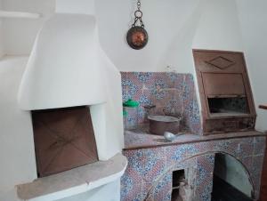 a kitchen with a counter with a stove and a oven at Villa MariaRosa in Lipari +38 photos