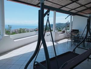 a balcony with chairs and a view of the ocean at Villa MariaRosa in Lipari