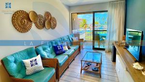 a living room with a couch and a table at La Fleur Collection Vacation Homes - Residence & Resort in Porto De Galinhas