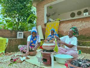 a group of three women sitting on the ground at Binta Boutique Hotel - Small Oasis near Nungwi Beach in Nungwi +61 photos