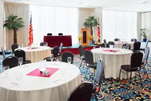 a conference room with tables and chairs and flags at Grand Hotel Ocean City Oceanfront in Ocean City +28 photos
