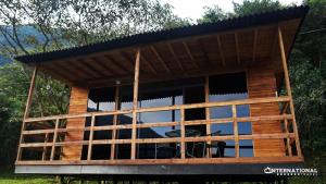 a house built out of wood with a large window at Refugio Tororoi in Copacabana