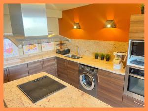 a kitchen with a sink and a washing machine at Les suites de la Villa Morane in Perpignan +7 photos