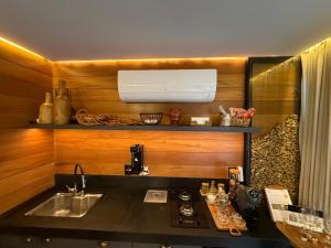 a kitchen with a sink and a counter top at Cabanas Araucária in Campos do Jordão +162 photos