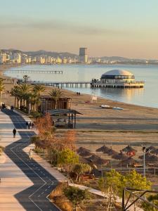 a view of a beach with a pier and the ocean at Wave Beachfront Apartments in Durrës