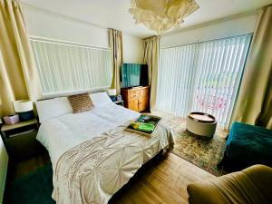 a bedroom with a bed with a book on it at Fintra Bay Hideaway in Killybegs